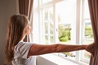 woman opening window