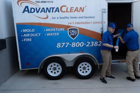 two men standing in front of a trailer