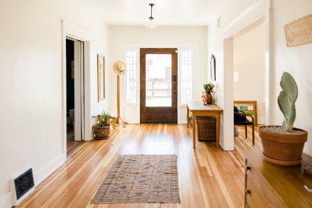 Hallway view in a home showing the front door.