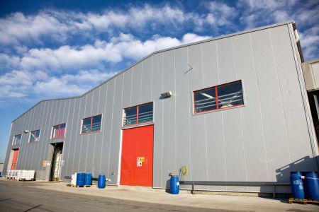 grey building with orange door