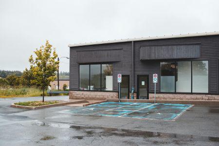 Black building with a wet parking lot