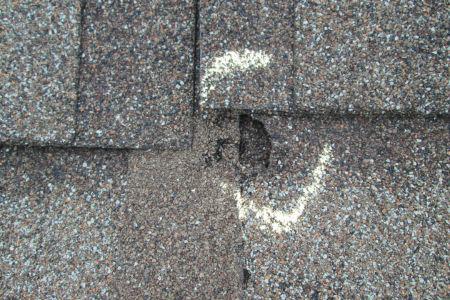 chalk circled around a whole in a roof