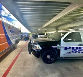 AdvantaClean truck by a police car