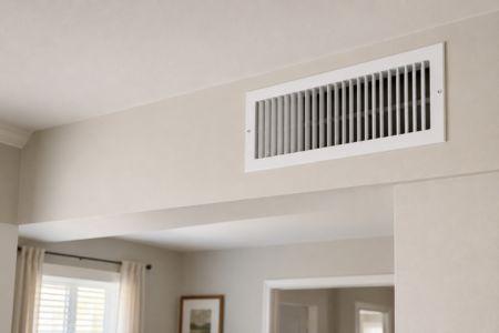 A clean wall air vent in a bright home shows how ductwork supports airflow and comfort during summer.