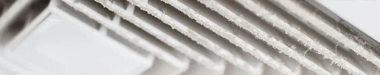 Close up image of an air duct with significant dust accumulation