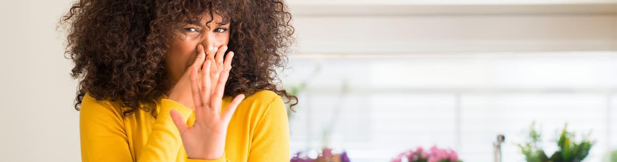 Woman holding her breath to prevent breathing in smoke