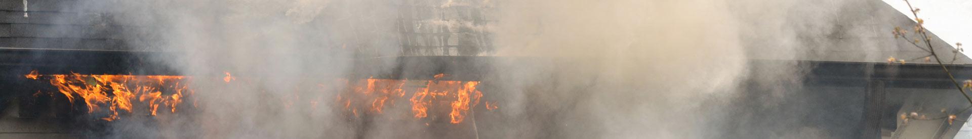 A building on fire with smoke