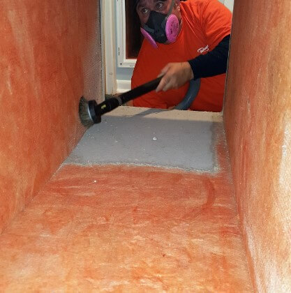 technician cleaning vent 