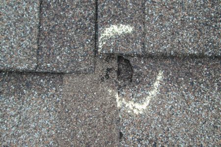 chalk circled around a whole in a roof