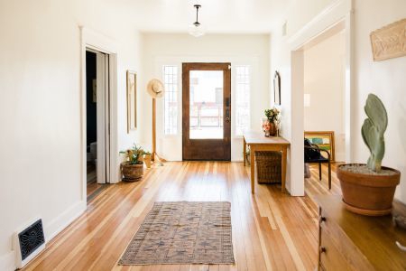 Hallway view in a home showing the front door.
