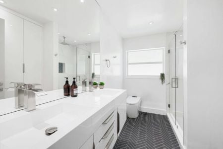 White bathroom with black flooring