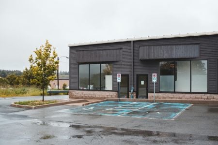 Black building with a wet parking lot